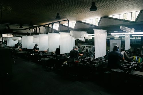 Workers at stations inside a factory
